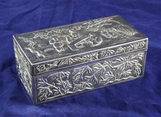 A Chinese Export commemorative silver cigarette box, Wang Hing & Co, embossed with figures in a garden, bamboo etc